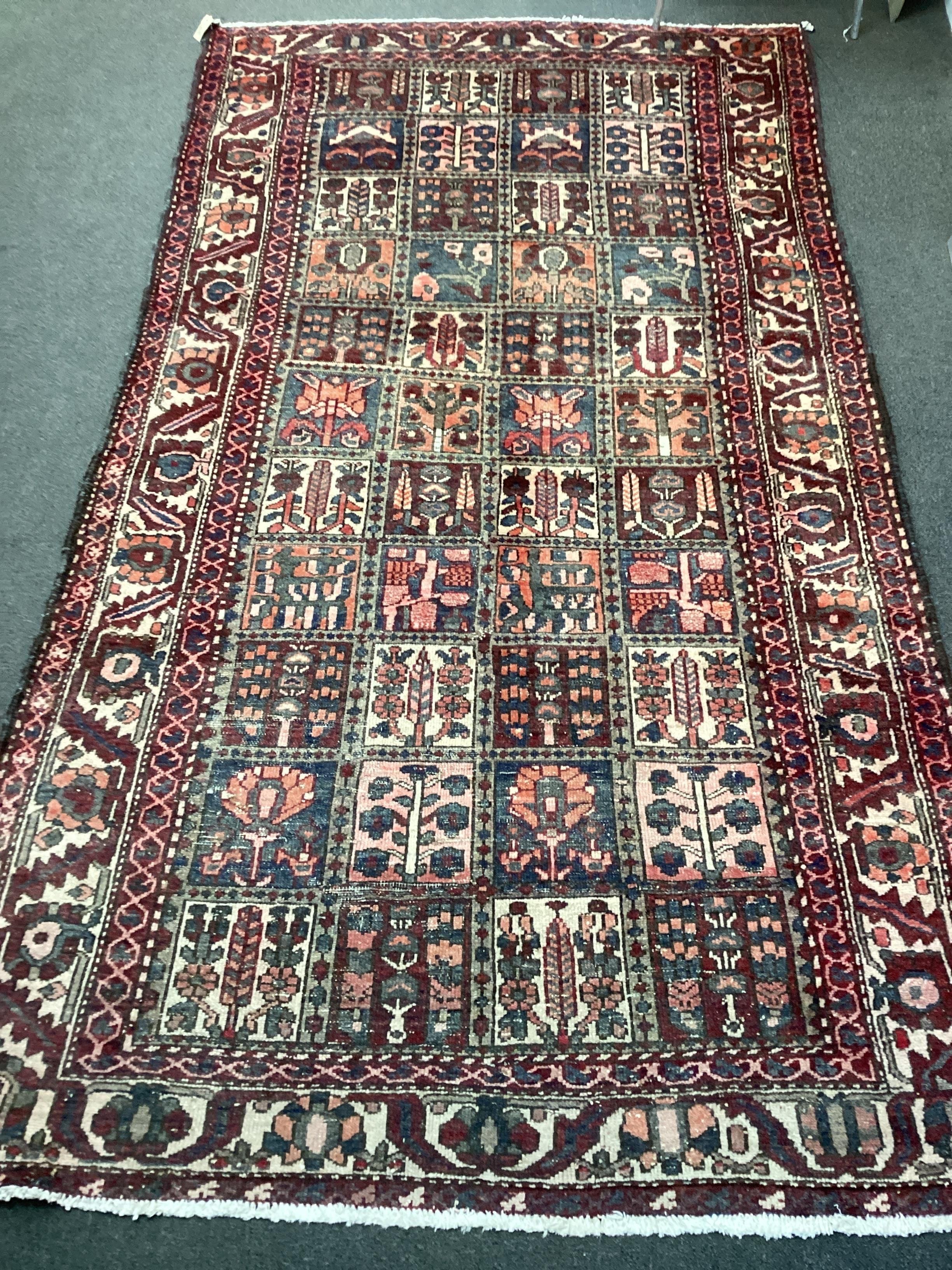 A Baktiari carpet woven panels of floral devices, 300cm x 156cm